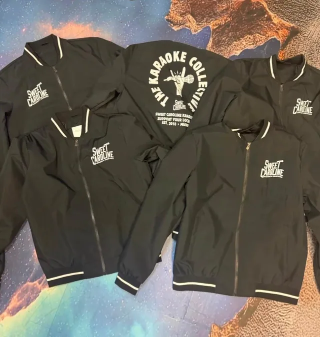 Collection of black printed shirts with white graphics displayed together