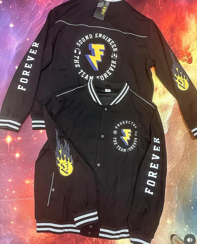 Matching black shirts and shorts with gold circular logo details