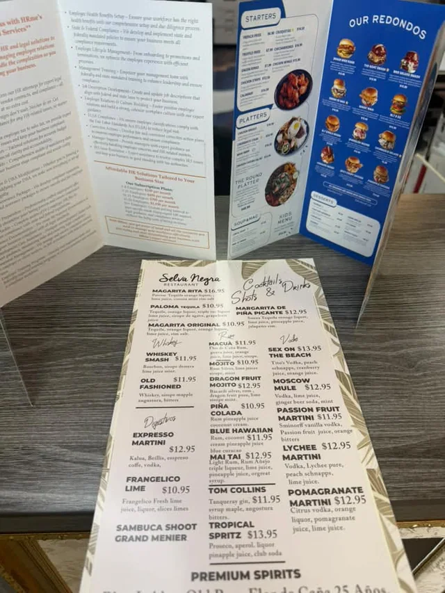 Printed business brochures and restaurant menus displayed at Masters of Print in Miami